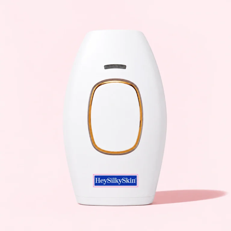IPL laser hair removal handset by HeySilkySkin, shown against a soft pink studio background.