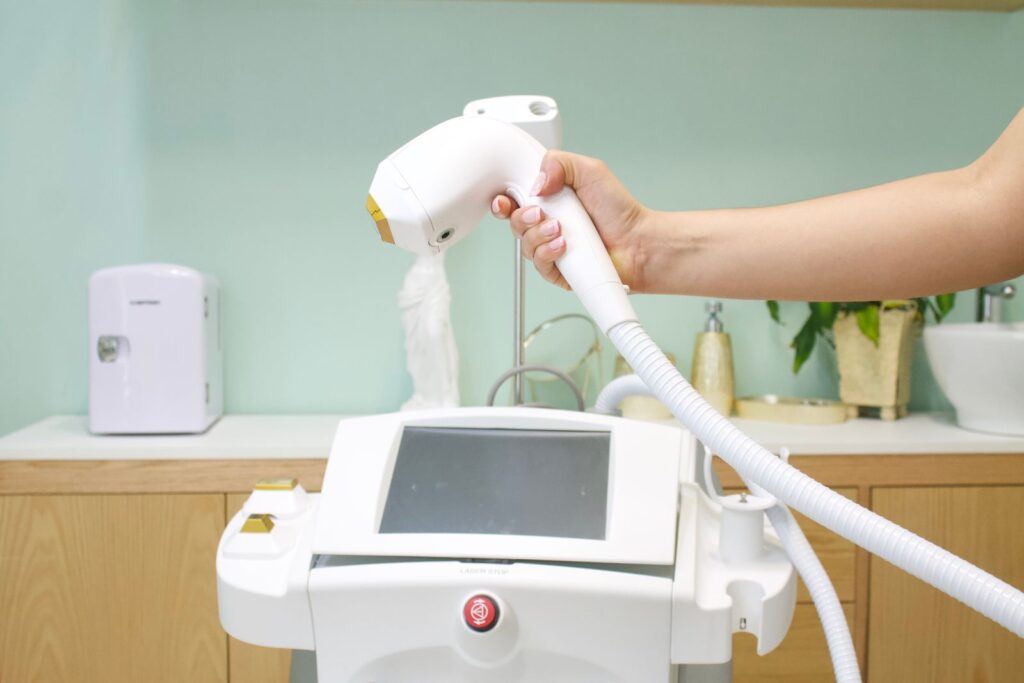 How at-home IPL works, showing an intense pulsed light handset and treatment machine