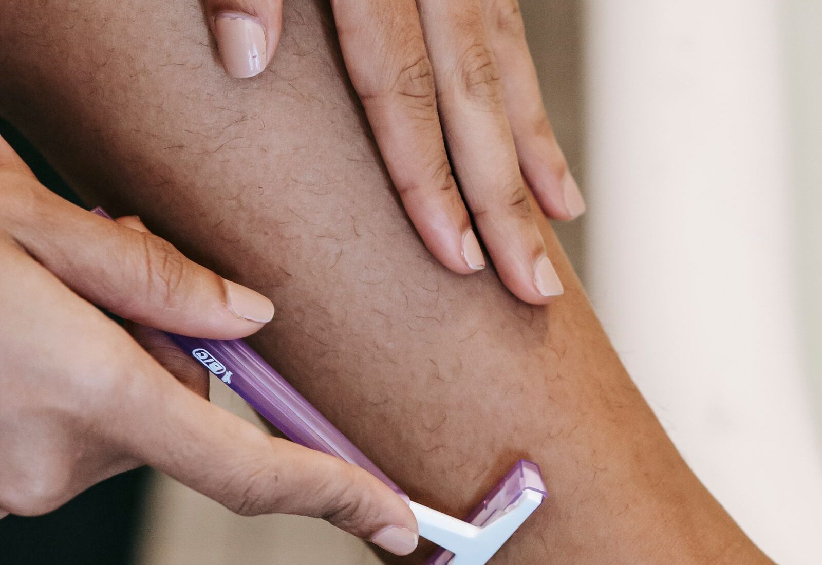IPL skin tone suitability shown by dark hair against medium brown skin on a leg