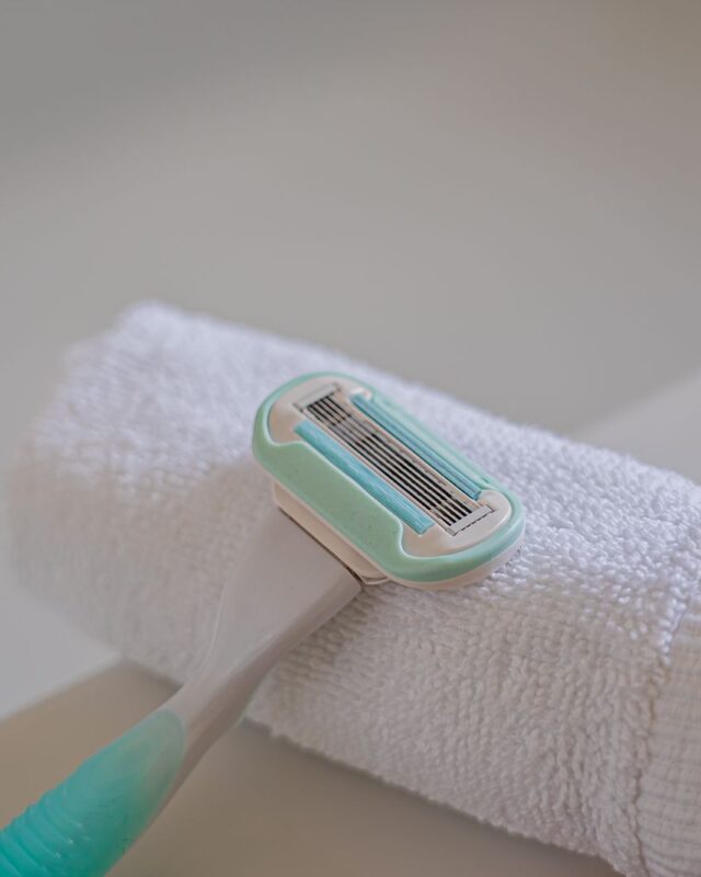 How often should you shave: a disposable razor resting on a rolled white towel