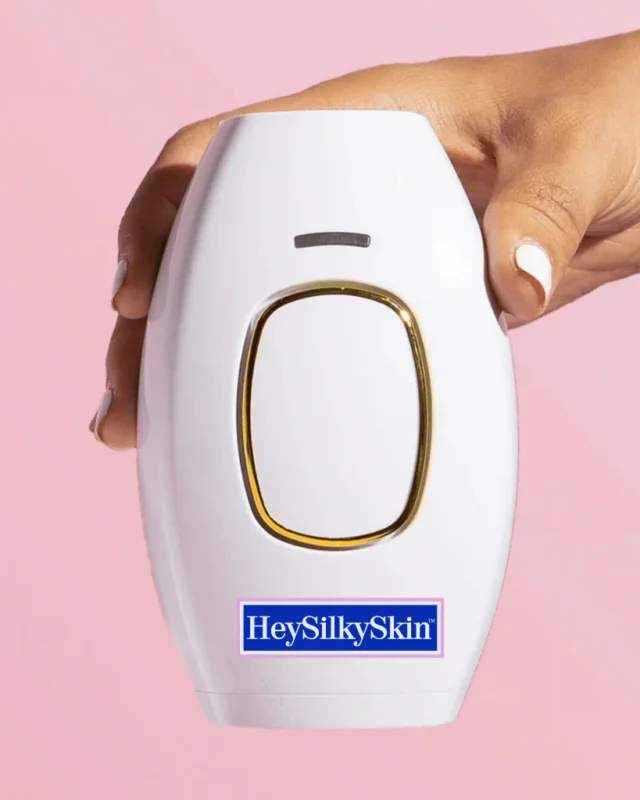 How to use the HeySilkySkin IPL handset: the white handset held in one hand against a pink background