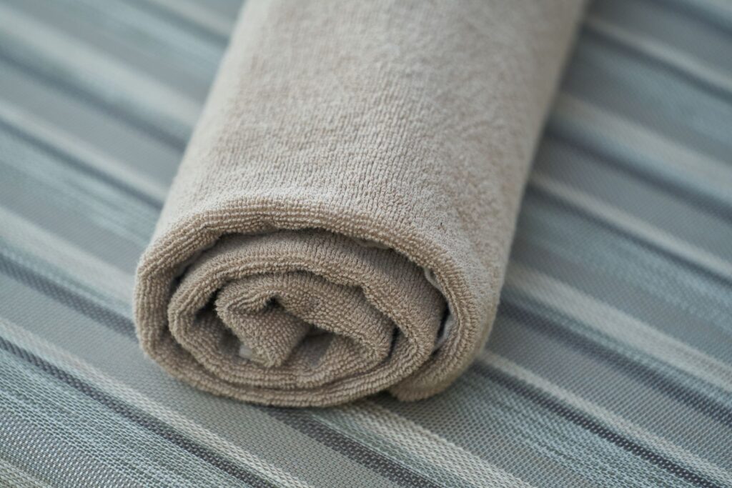 Rolled cotton towel used as a cool damp compress for itchy skin after shaving