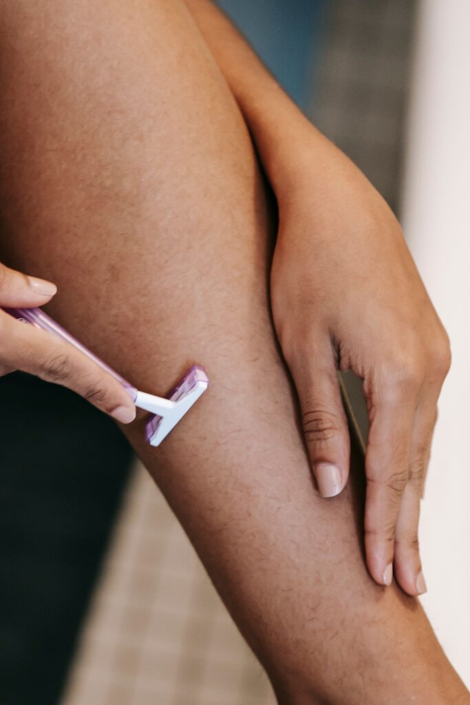 Dry shaving the upper thigh with a disposable razor, a common cause of razor burn on the bikini area